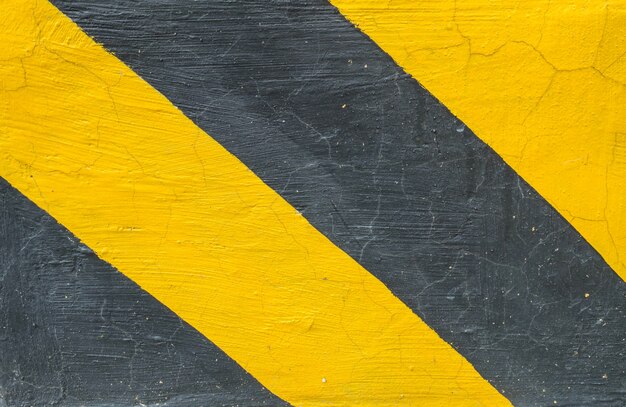 Closeup surface of old yellow and black painted cement floor texture