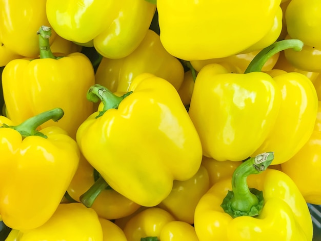 Closeup surface pile of yellow bell pepper or sweet pepper textured background