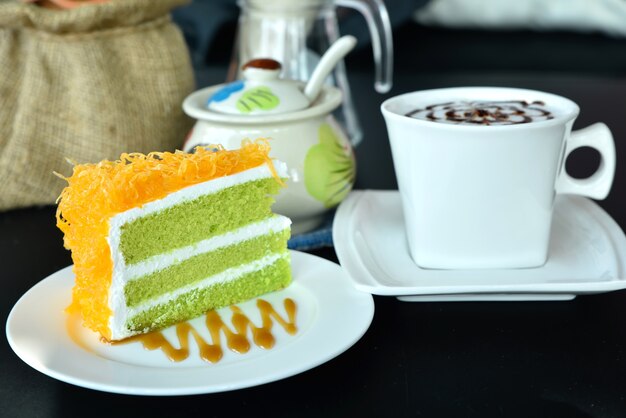 Closeup sweet cake with coofee cup on the table