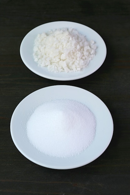 Closeup of Table Salt with Blurry Sea Salt on Black Background