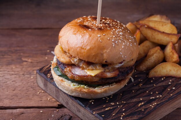 Closeup of a tasty Burger with snacks.