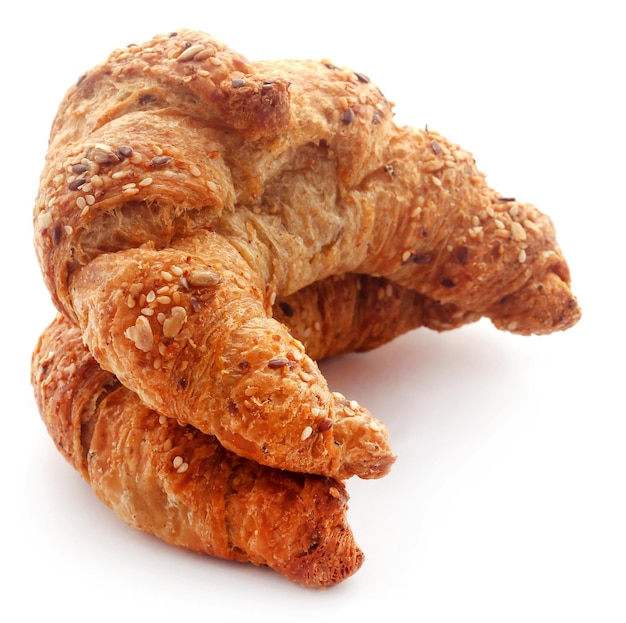 Closeup of tasty croissant over white background