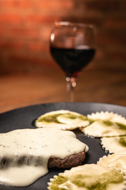 Closeup of tasty meal on a wooden cutting board with brick wall on background