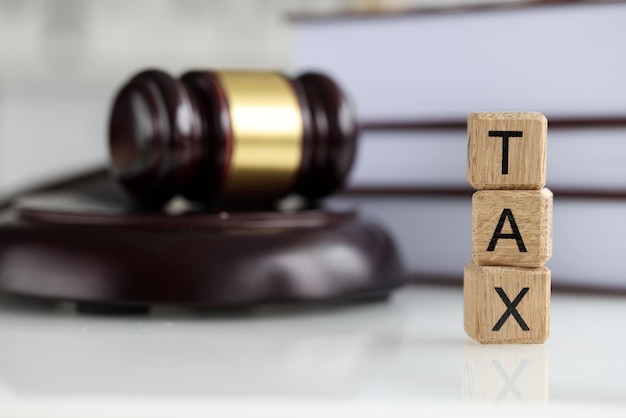 Closeup of tax word collected of wooden blocks letters taxfilling government state taxes