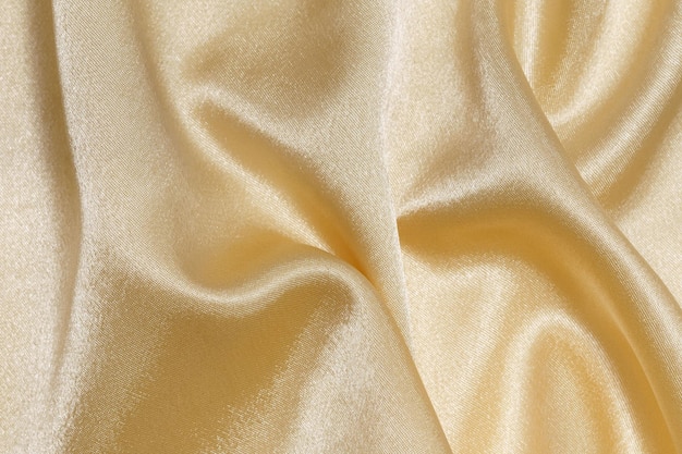 closeup texture of golden cloth crumpled and wrinkled background for your design material for sewing