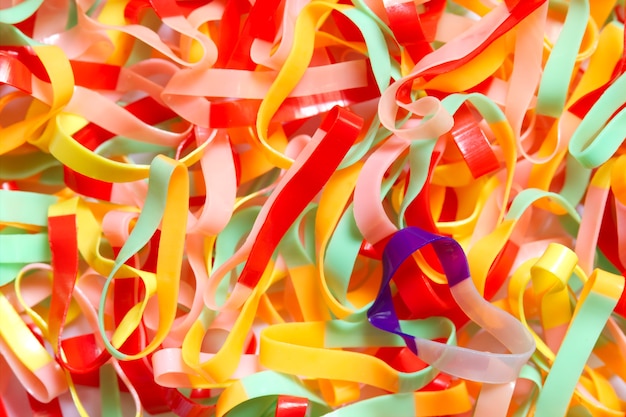 Photo closeup texture of many the rubber band for use to tie the hair is stacked in bright light.