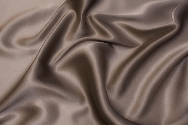 Closeup texture of natural beige fabric or cloth in brown color Fabric texture of natural cotton or linen textile material Beige canvas background