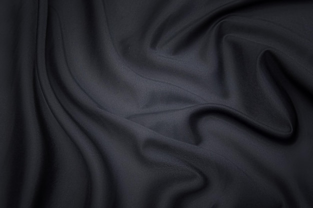 Closeup texture of natural gray fabric or cloth in black color Fabric texture of natural cotton or linen textile material Gray or black canvas background