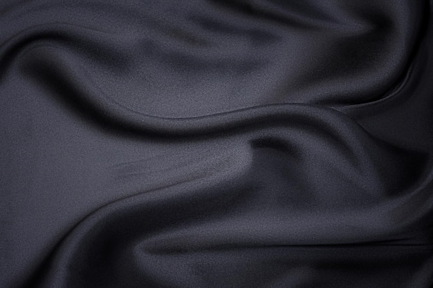 Closeup texture of natural gray fabric or cloth in black color Fabric texture of natural cotton or linen textile material Gray or black canvas background