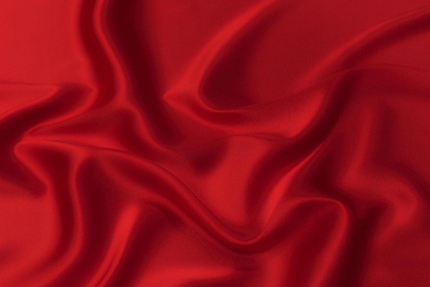 Closeup texture of natural red or pink fabric or cloth in same color Fabric texture of natural cotton silk or wool or linen textile material Red and orange canvas background