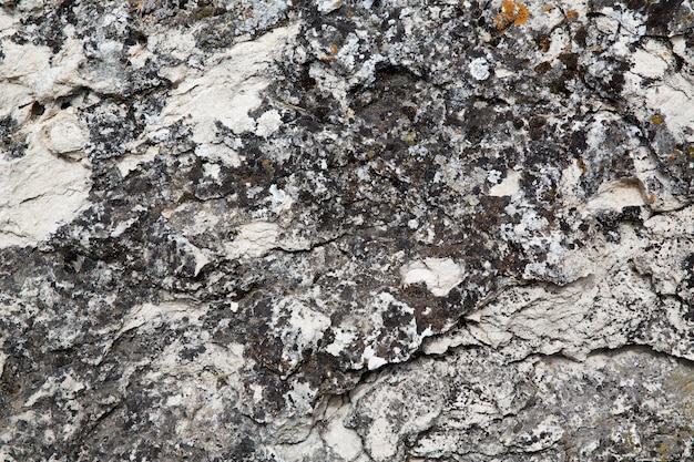 Closeup texture of old cracked stone wall