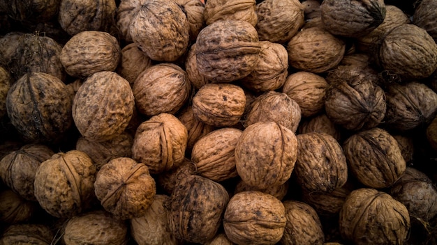 Closeup texture of raw walnuts in shells