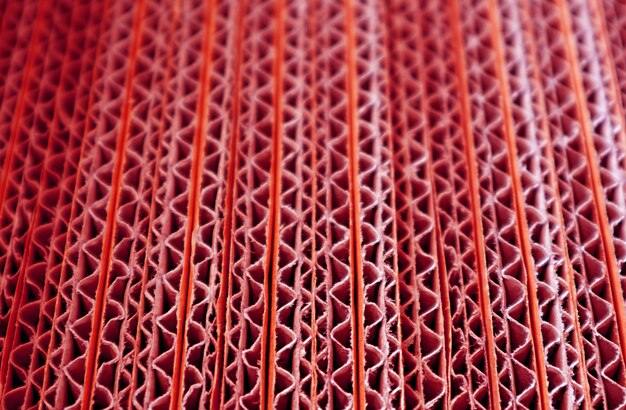 Closeup Texture of Unfold Red colored Corrugated Paper Boxes Stack