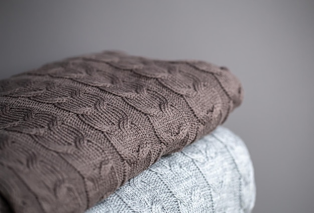 Closeup of textured knitted blankets in a stack