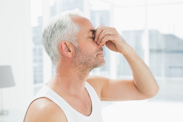 Closeup of a thoughtful mature man in bed