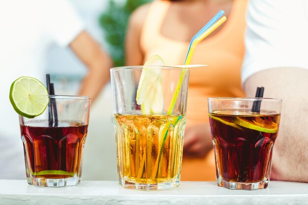 Photo closeup of three creative sweet alcoholic party cocktails in summer bar