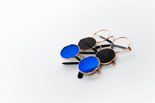 Closeup of three round sunglasses isolated on white background with copy space.