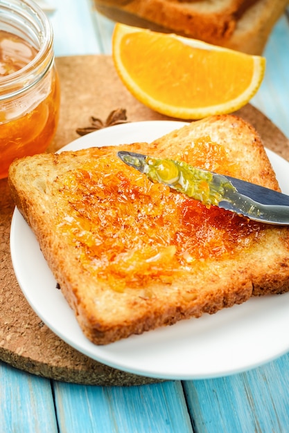 Closeup toasts with orange jam on blue