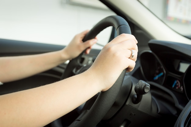 Closeup toned photo of woman driving car