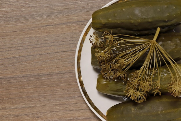 Closeup on top of pickles on a platter with dill umbel