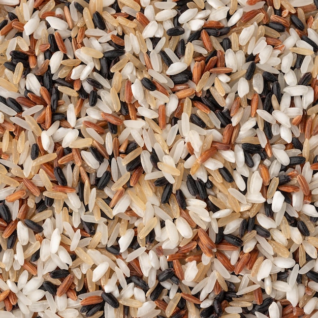 Closeup, top view of assorted raw rice. Food backdrop.