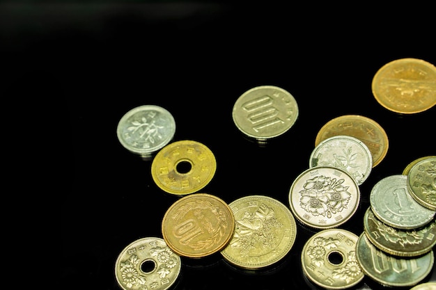 Photo closeup and top view of japan currency coins isolate on black background