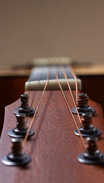 Closeup of the tuning pegs of an acoustic guitar