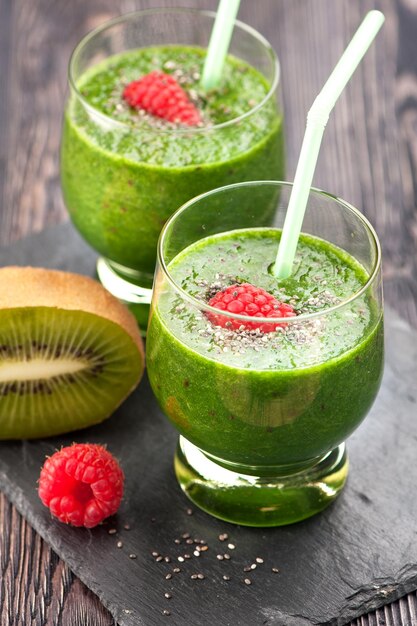 Closeup of two glasses of green smoothies