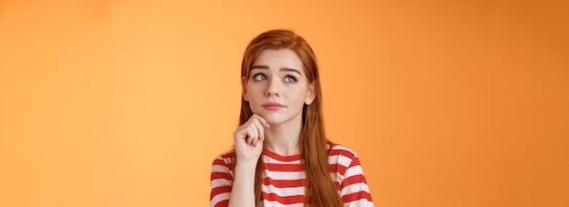 Photo closeup uneasy cute redhead female student facing tough troublesome decision thinking intense look u