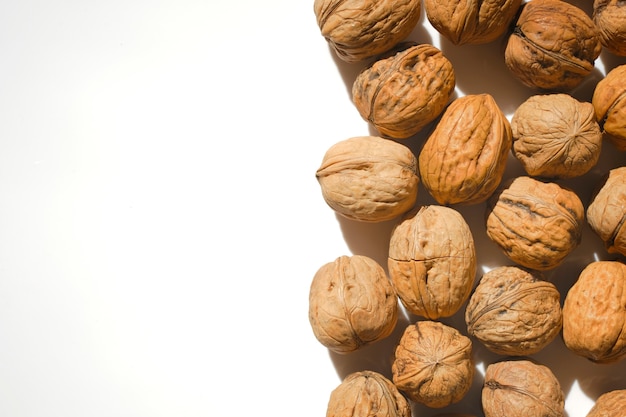 Closeup of unpeeled walnuts on a light background