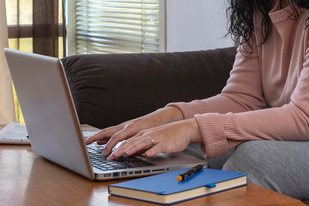 Photo closeup of an unrecognizable executive woman completing a promising job with the help of a laptop while working from home