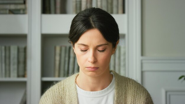 Photo closeup of upset girl sad tense sitting at home