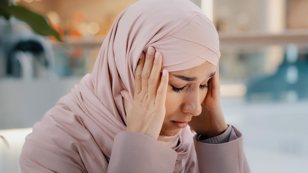 Closeup upset young woman gets bad news feels stressful anxiety frustrated muslim girl suffers from