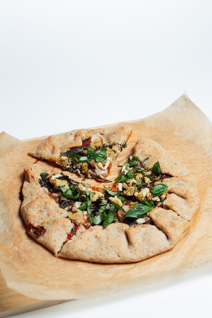 Closeup of vegan galette on parchment paper White background Homemade food