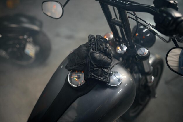 Closeup view on biker leather gloves on motorcycle gas tank