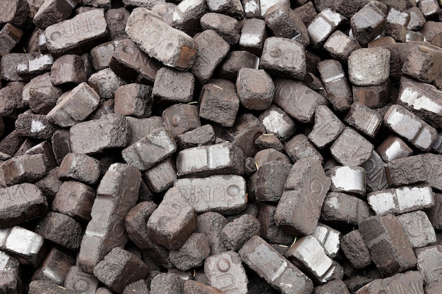 Closeup view of black charcoal, coal briquets. Coal texture background. Energy resource, heating, industrial use.