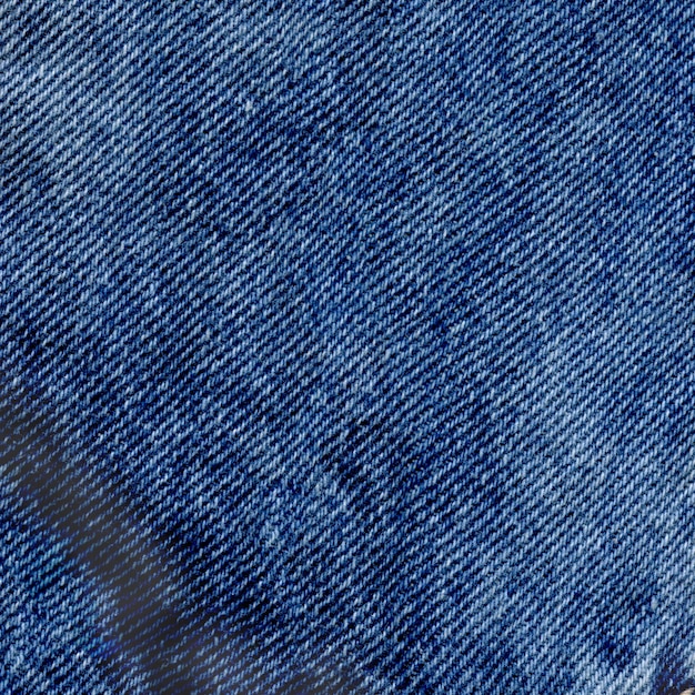 Photo closeup view blue clean denim texture. blue torn jeans texture