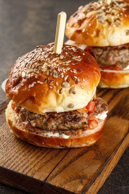 Closeup view of burger on wooden plate