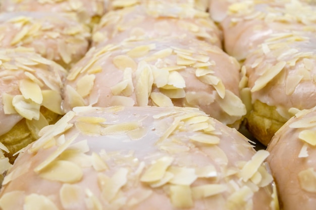 A closeup view of delicious donuts with icing and almond sprinkles