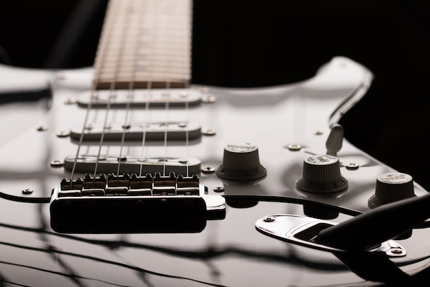 Closeup view of electric guitar in dark key