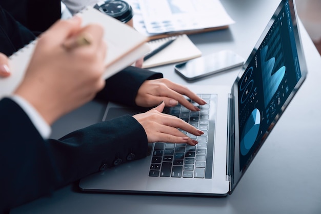 Closeup to view hand using laptop to analyze financial data in harmony office