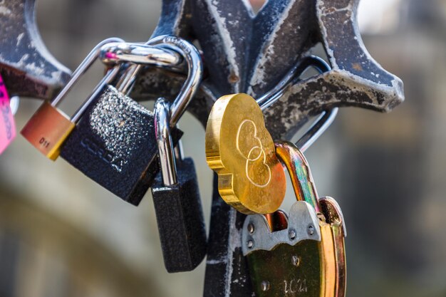 Closeup view of heartshaped love padlock hanging on a bridge fence