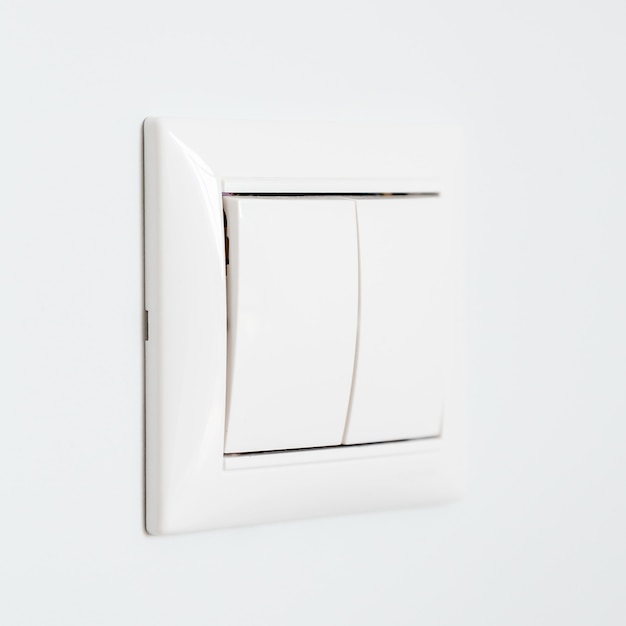 Closeup view of light switch on white wall background