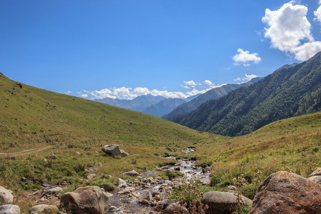 Closeup view mountains scenes in national park Dombai, Caucasus, Russia, Europe. Summer landscape, sunshine weather, dramatic blue sky and sunny day