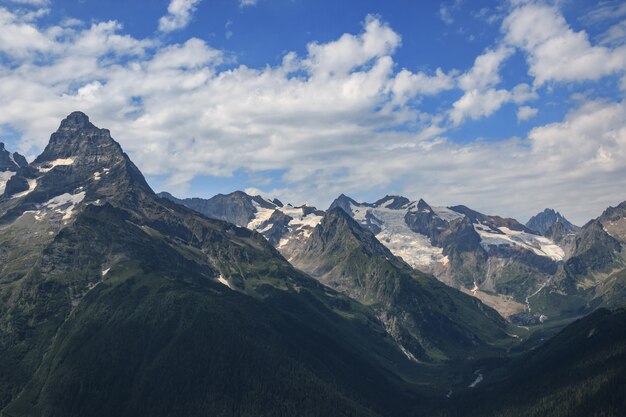 Closeup view mountains scenes in national park Dombai, Caucasus, Russia, Europe. Summer landscape, sunshine weather, dramatic blue sky and sunny day