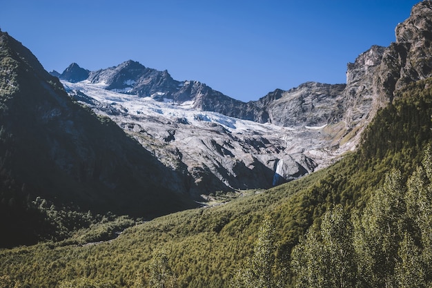 Closeup view of mountains scenes in national park Dombay, Caucasus, Russia, Europe. Summer landscape and sunny blue sky