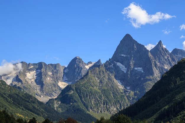 Closeup view of mountains scenes in national park Dombay, Caucasus, Russia, Europe. Summer landscape and sunny blue sky