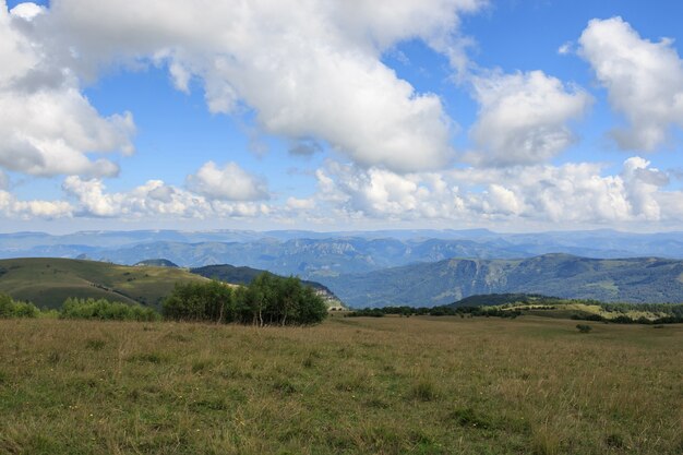 Closeup view mountains and valley scenes in national park Dombai, Caucasus, Russia, Europe. Summer landscape, sunshine weather, dramatic blue sky and sunny day