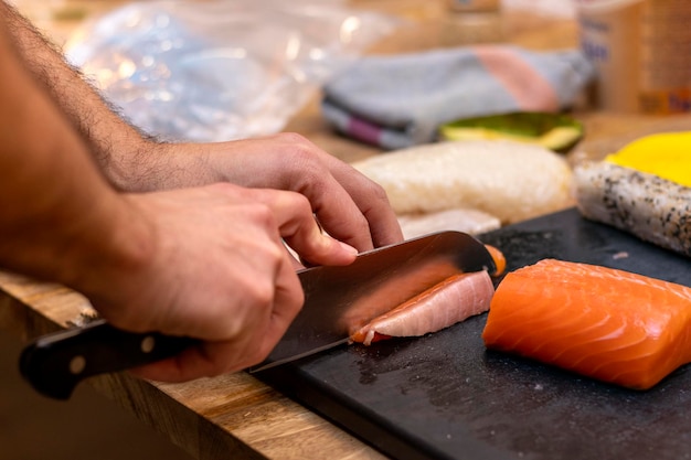 Closeup view of process of preparing delicious rolling sushi in restaurant