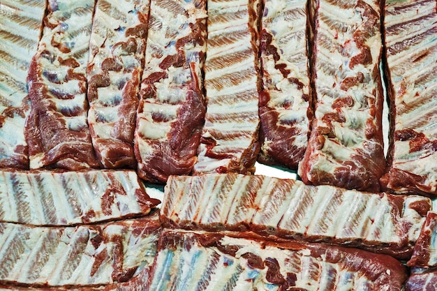 Photo closeup view of raw marinated ribs ready for cooking